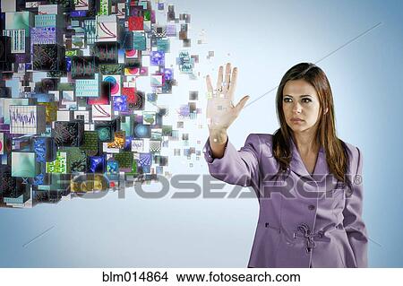Picture - Businesswoman holding hand out toward digital images. Fotosearch