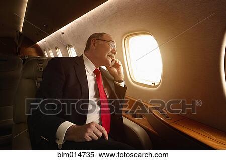 Caucasian businessman flying on private jet View Large Photo Image Stock Photography - Caucasian businessman flying on private jet. Fotosearch