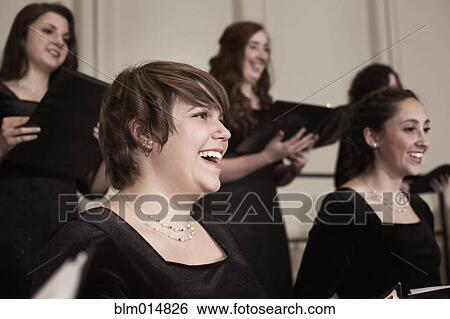 Stock Photograph - Caucasian choir performing on stage. Fotosearch