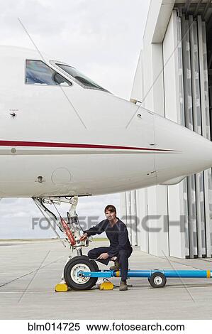 Caucasian flight engineer looking at jet View Large Photo Image Stock Photography - Caucasian flight engineer looking at jet. Fotosearch