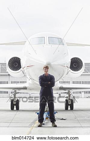 Caucasian flight engineer standing near jet View Large Photo Image Picture - Caucasian flight engineer standing near jet. Fotosearch