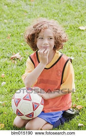 Caucasian girl sitting in grass with soccer ball View Large Photo Image Stock Image - Caucasian girl sitting in grass with soccer ball. Fotosearch