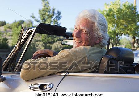 Stock Photo - Caucasian man driving convertible. Fotosearch