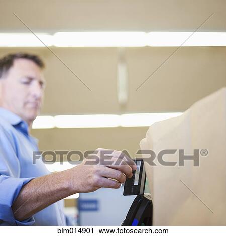 Caucasian man paying with credit card View Large Photo Image Stock Image - Caucasian man paying with credit card. Fotosearch