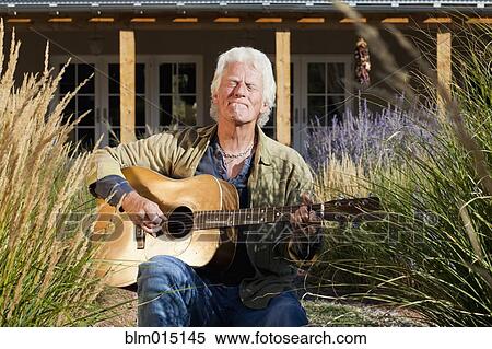 Caucasian man playing guitar View Large Photo Image Stock Photography - Caucasian man playing guitar. Fotosearch