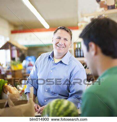 Caucasian man shopping in grocery store View Large Photo Image Stock Image - Caucasian man shopping in grocery store. Fotosearch