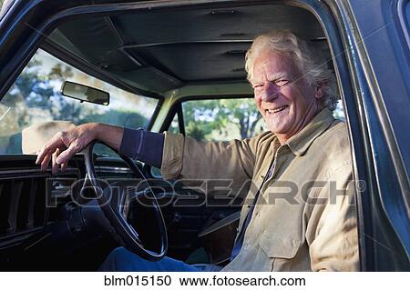 Caucasian man sitting in truck View Large Photo Image Stock Image - Caucasian man sitting in truck. Fotosearch