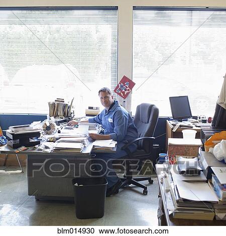 Caucasian man working at desk View Large Photo Image Stock Image - Caucasian man working at desk. Fotosearch