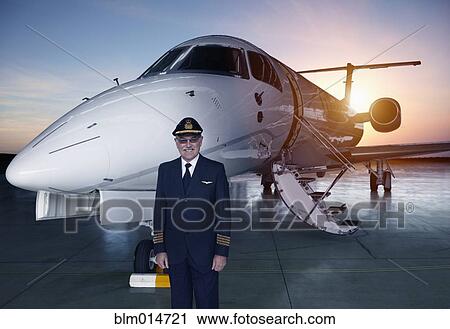 Caucasian pilot standing near jet View Large Photo Image Stock Image - Caucasian pilot standing near jet. Fotosearch