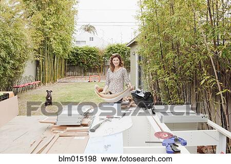 Stock Photo - Caucasian woman looking at blueprints. Fotosearch