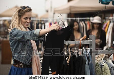 Caucasian woman shopping at flea market View Large Photo Image Stock Photo - Caucasian woman shopping at flea market. Fotosearch