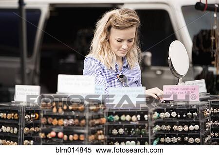 Stock Photography - Caucasian woman shopping at flea market. Fotosearch