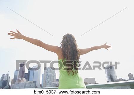 Caucasian woman standing on city balcony View Large Photo Image Stock Photo - Caucasian woman standing on city balcony. Fotosearch