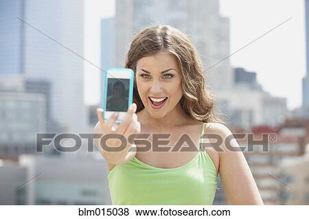 Caucasian woman taking self-portrait with cell phone View Large Photo Image Stock Photo - Caucasian woman taking self-portrait with cell phone. Fotosearch