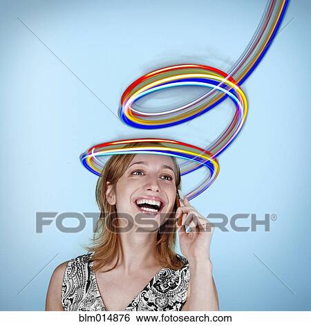 Caucasian woman talking on cell phone with colorful lines above her head View Large Photo Image Stock Photograph - Caucasian woman talking on cell phone with colorful lines above her head. Fotosearch