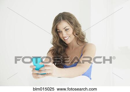 Caucasian woman text messaging on cell phone View Large Photo Image Stock Photography - Caucasian woman text messaging on cell phone. Fotosearch