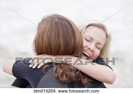 Picture - Caucasian women hugging. Fotosearch
