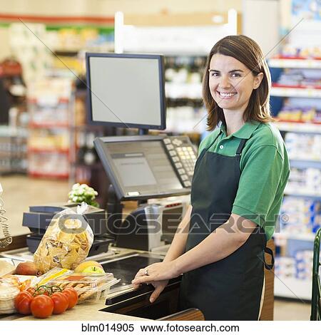Caucasian worker at register in grocery store View Large Photo Image Stock Photography - Caucasian worker at register in grocery store. Fotosearch