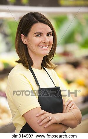 Stock Photo - Caucasian worker in grocery store. Fotosearch