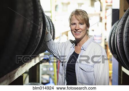 Picture - Caucasian worker in tire store. Fotosearch