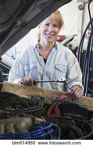 Caucasian worker working on automobile engine View Large Photo Image Stock Photo - Caucasian worker working on automobile engine. Fotosearch
