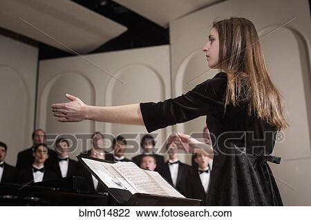 Conductor leading choir on stage View Large Photo Image Stock Image - Conductor leading choir on stage. Fotosearch
