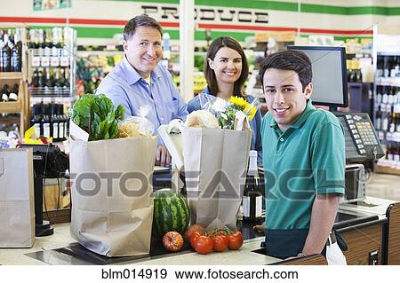 Customers and cashier in grocery store View Large Photo Image Stock Photo - Customers and cashier in grocery store. Fotosearch