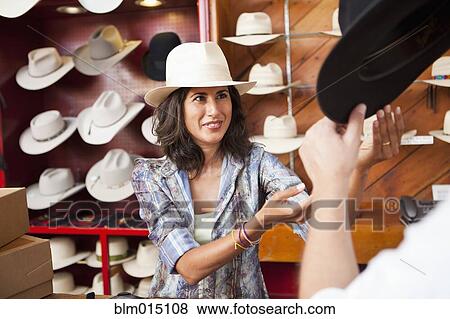 Stock Photo - Ecuadorian woman working in hat store. Fotosearch