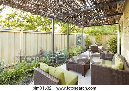 Stock Image - Elegant furniture on covered patio. Fotosearch