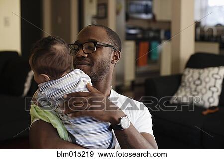 Father holding baby View Large Photo Image Stock Photo - Father holding baby. Fotosearch
