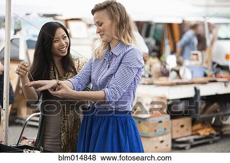 Friends shopping at flea market View Large Photo Image Stock Photo - Friends shopping at flea market. Fotosearch