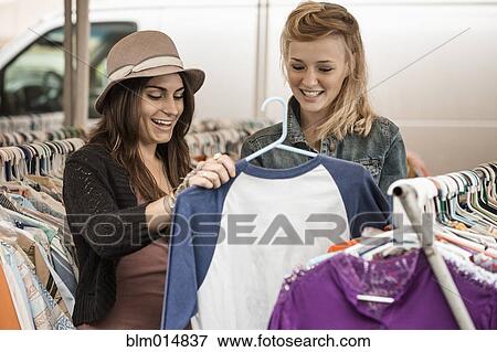Friends shopping for clothing View Large Photo Image Stock Photo - Friends shopping for clothing. Fotosearch