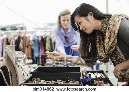 Friends shopping for jewelry in flea market View Large Photo Image Stock Image - Friends shopping for jewelry in flea market. Fotosearch