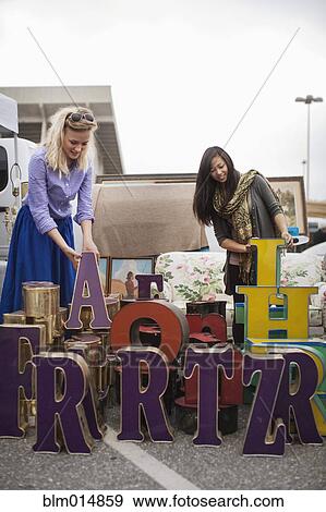 Friends shopping in flea market View Large Photo Image Stock Photo - Friends shopping in flea market. Fotosearch