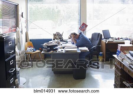 Frustrated Caucasian man working at desk View Large Photo Image Stock Image - Frustrated Caucasian man working at desk. Fotosearch