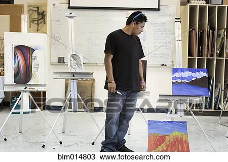 Stock Image - Hispanic artist in studio. Fotosearch