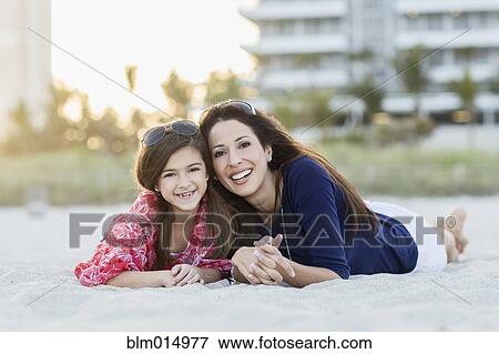 Hispanic mother and daughter laying on beach View Large Photo Image Stock Photo - Hispanic mother and daughter laying on beach. Fotosearch