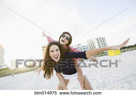 Hispanic mother and daughter playing on beach View Large Photo Image Stock Photography - Hispanic mother and daughter playing on beach. Fotosearch