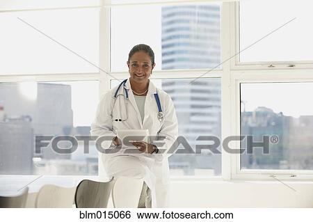 Indian doctor using digital tablet View Large Photo Image Stock Photograph - Indian doctor using digital tablet. Fotosearch