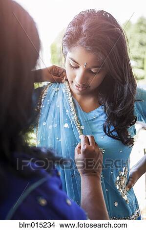 Picture - Indian mother and daughter in traditional clothing. Fotosearch