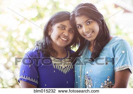 Stock Image - Indian mother and daughter in traditional clothing. Fotosearch