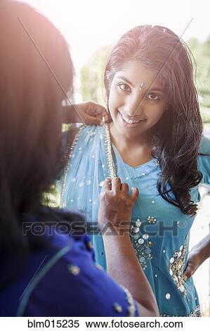 Stock Photography - Indian mother and daughter in traditional clothing. Fotosearch