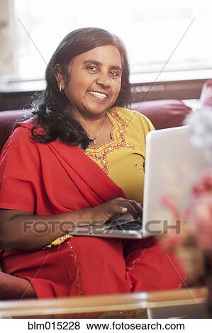 Stock Photo - Indian woman using digital tablet. Fotosearch