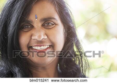Stock Image - Indian woman with jewel on forehead. Fotosearch