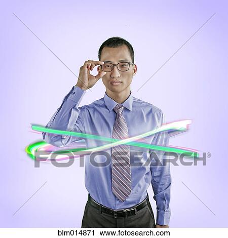 Stock Image - Korean businessman surrounded by glowing lines. Fotosearch