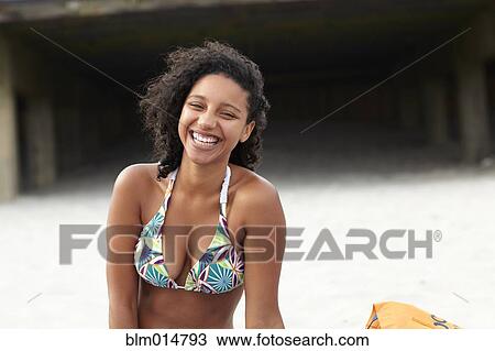 Laughing mixed race woman on beach View Large Photo Image Stock Image - Laughing mixed race woman on beach. Fotosearch