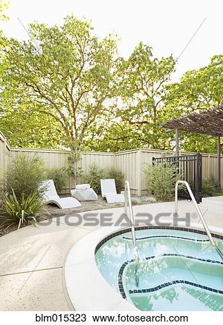 Stock Image - Lounge chairs near swimming pool. Fotosearch