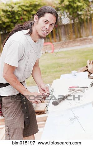 Mixed race construction worker working View Large Photo Image Stock Photo - Mixed race construction worker working. Fotosearch