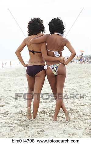 Mixed race friends hugging on beach View Large Photo Image Stock Photo - Mixed race friends hugging on beach. Fotosearch
