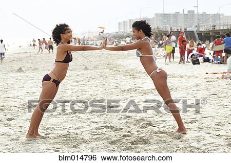 Mixed race friends playing on beach View Large Photo Image Stock Photograph - Mixed race friends playing on beach. Fotosearch